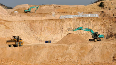Workers use machinery to dig at a rare earth mine in Ganxian county in central China's Jiangxi province on Dec. 30, 2010.