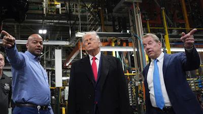 President Donald Trump listens to Corey Williams, Ford River Rouge Plant Manager, left, and Bill Ford, Executive Chairman of Ford, during a tour of the Ford River Rogue complex, Tuesday, Jan. 13, 2026, in Dearborn, Mich.