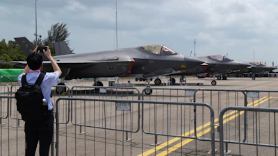 A man takes a picture of a row of F-35 Lightning II fighter jets during the Singapore Air Show on Thursday, Feb. 5, 2026.