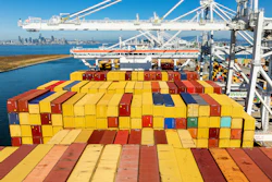 Cargo containers line a ship at the Port of Oakland, Oakland, Calif., Aug. 6, 2025.