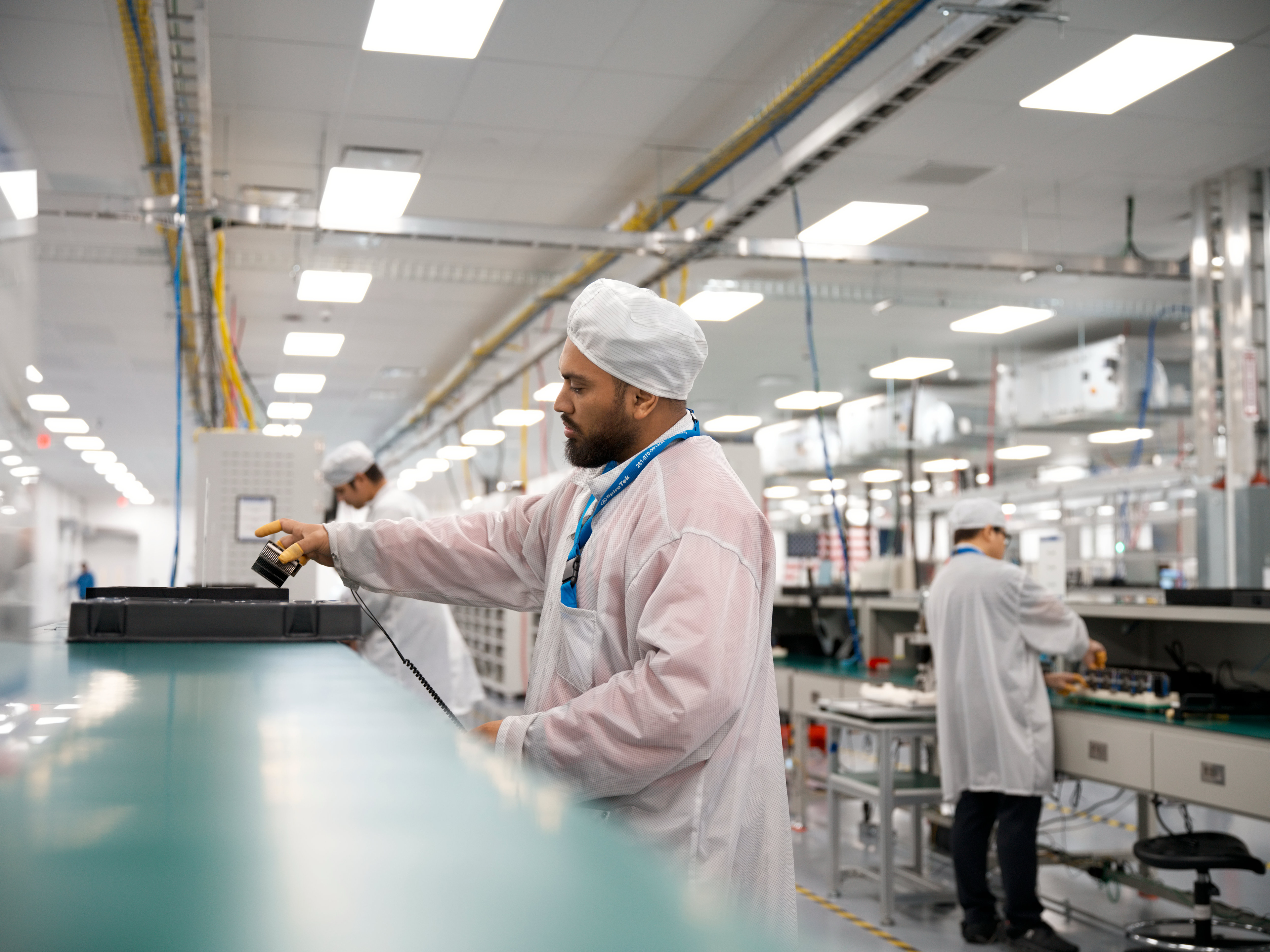 In Houston, workers assemble advanced AI servers, including logic boards produced onsite, which are then used in Apple data centers in the U.S.