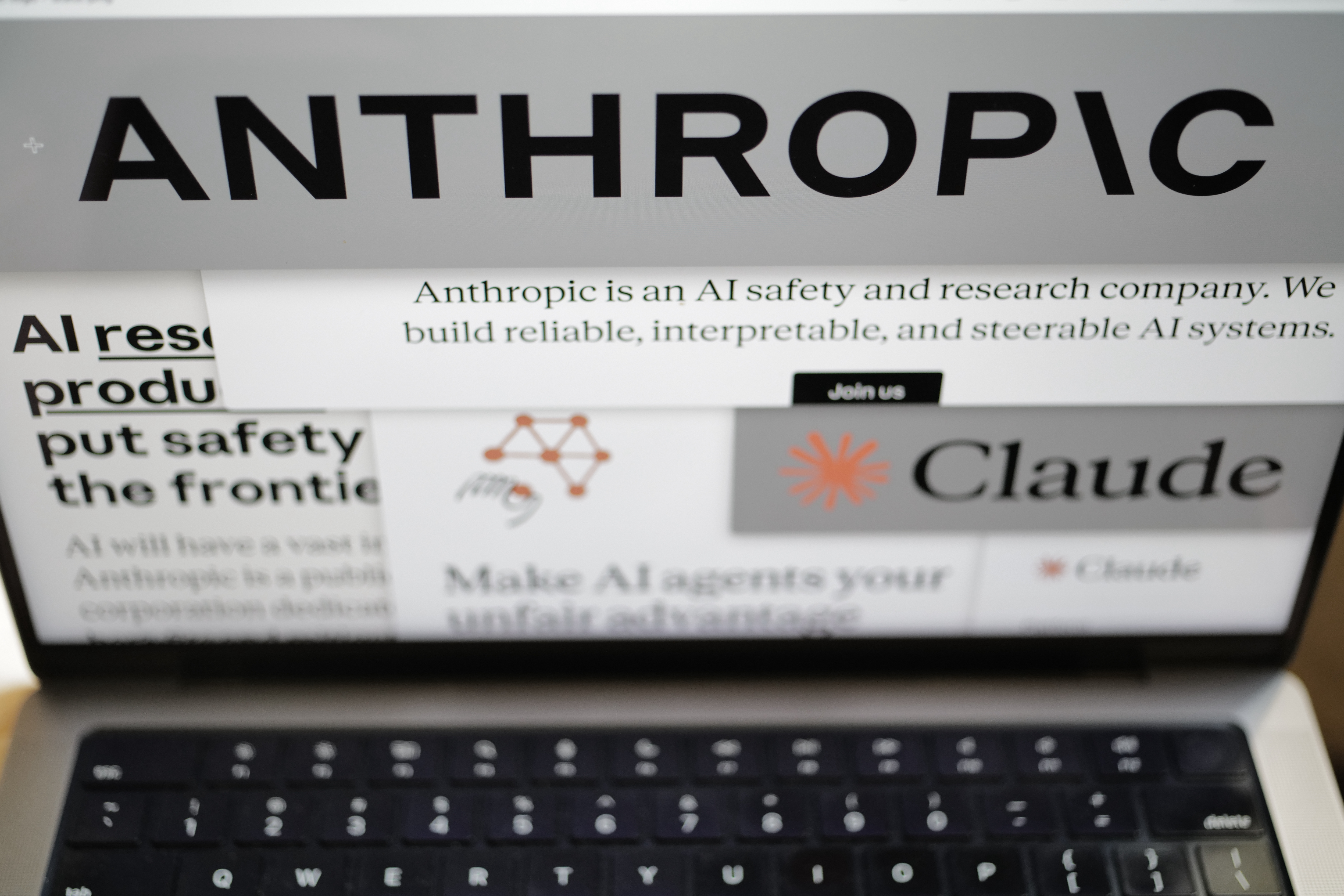 Pages from the Anthropic website and the company's logos are displayed on a computer screen in New York on Thursday, Feb. 26, 2026.