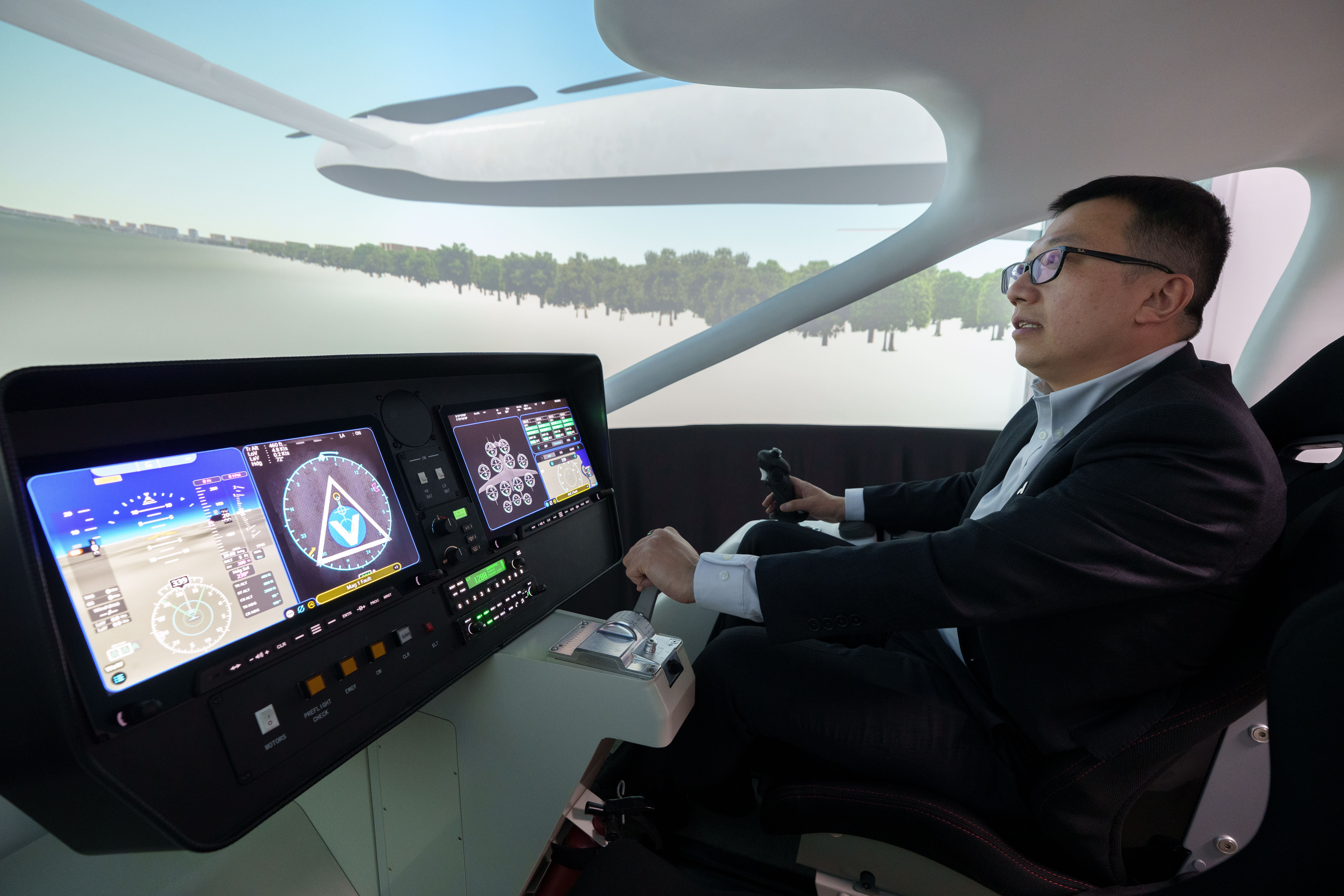 Steven Yang, senior vice president of AutoFlight, demonstrates at a flying simulation of its company's eVTOL aircraft in Shanghai, China, on Feb. 24, 2026.