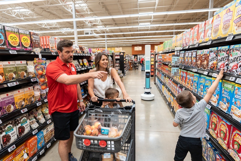 Family In Grocery Store With Tally Robot