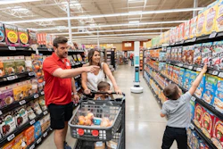 Family In Grocery Store With Tally Robot