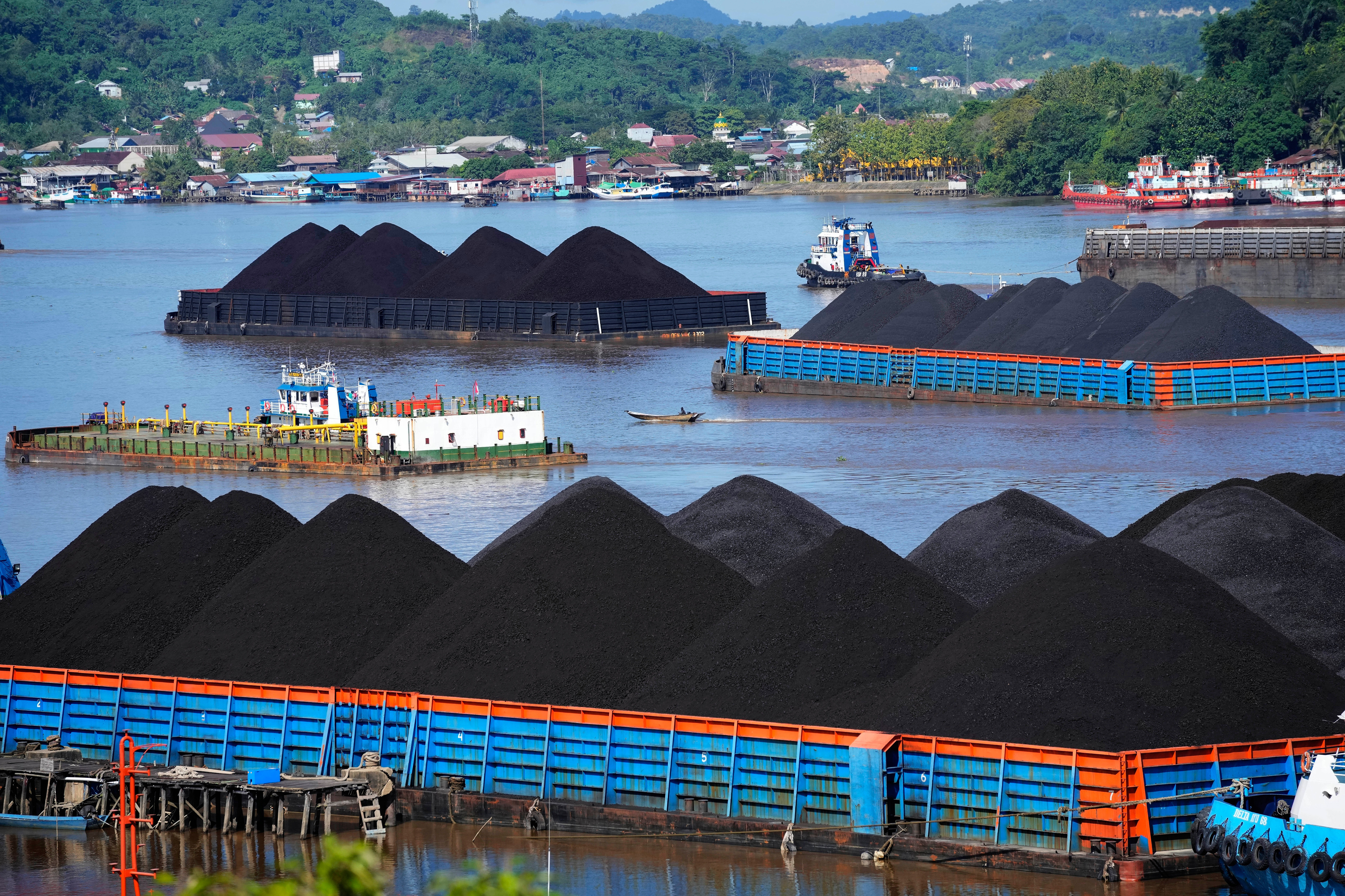 Barges fully loaded with coal are anchored on Mahakam river in Samarinda, East Kalimantan, Indonesia, on Dec. 19, 2022.