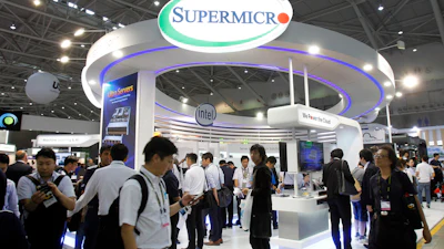 Visitors walk past a Super Micro Computer Inc. booth at the Computex Taipei exhibition in Taipei, Taiwan, June 5, 2018.