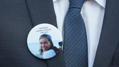 A family member wears a photo of a Boeing crash victim Danielle Moore before a hearing at federal court in Fort Worth, Texas, Sept. 3, 2025.