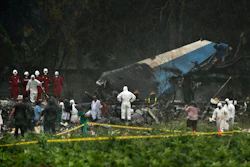 Rescue teams search through the wreckage site of a Boeing 737 that plummeted into a cassava field with more than 100 passengers on board, in Havana, Cuba, May 18, 2018.