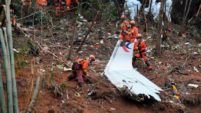 In this photo released by Xinhua News Agency, search and rescue workers search through debris at the China Eastern flight crash site in Tengxian County in southern China's Guangxi Zhuang Autonomous Region on March 24, 2022.