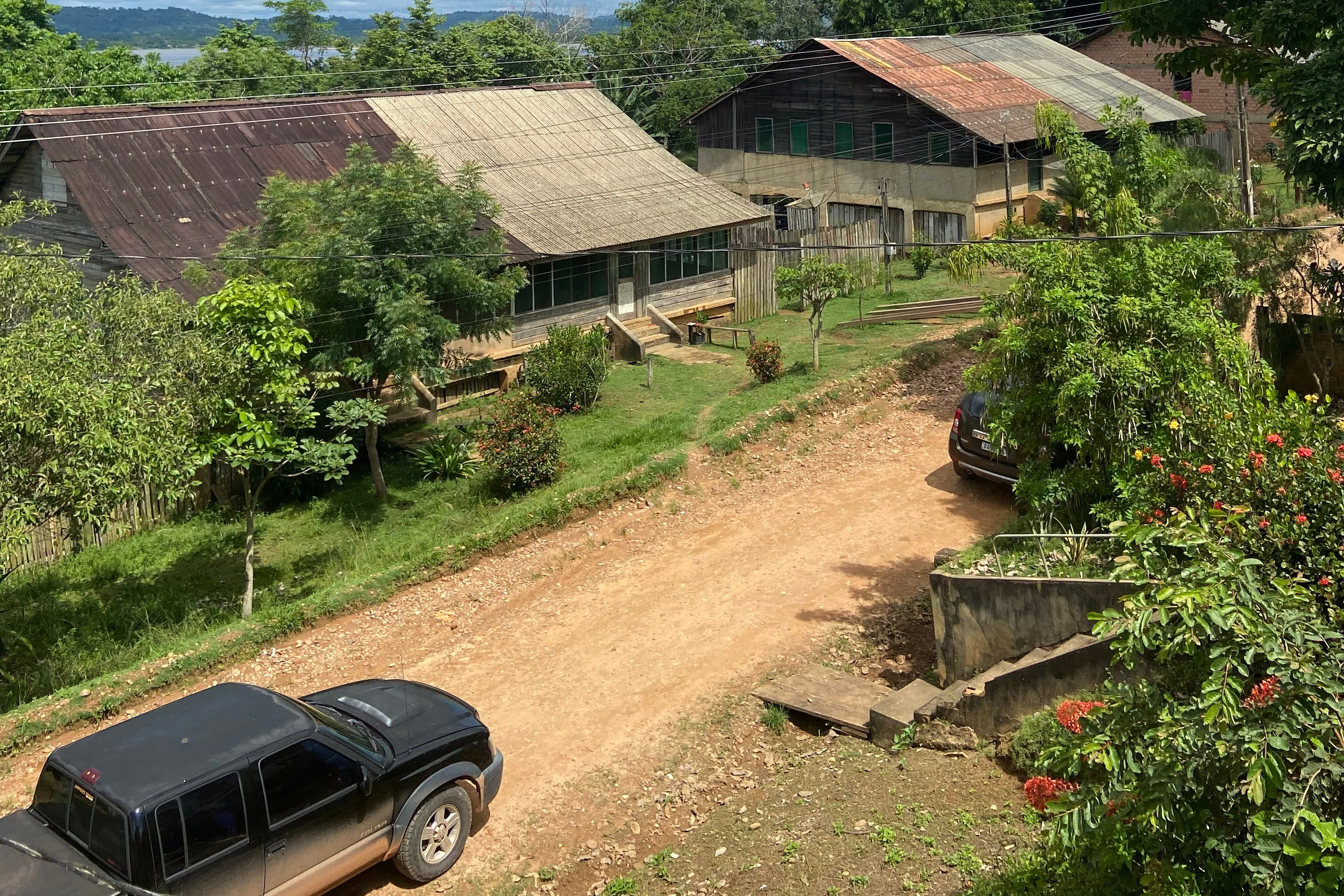This photo provided by the Brazilian Federal Justice shows a truck driving past buildings in Fordlandia, Para, Brazil, Dec. 6, 2021.