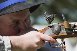 A.J. Drake, a historic interpreter, aims his Brown Bess flintlock replica musket during a Revolutionary War event in Halifax, N.C., on April 10, 2026.