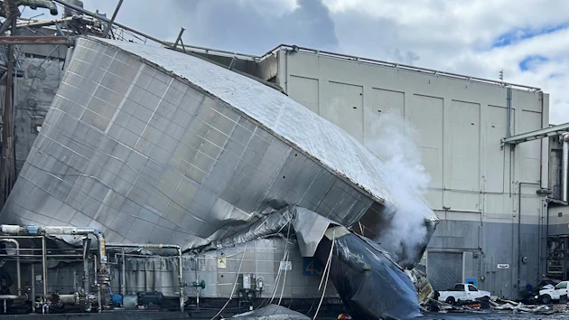 This photo provided by the City of Longview, Wash., shows structural damage to the Nippon Dynawave Packaging Co., after a tank containing hazardous liquid imploded, on Tuesday, May 26, 2026 in Longview, Wash.
