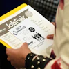 A job seeker waits to talk to a recruiter at a job fair, Aug. 28, 2025, Sunrise, Fla.