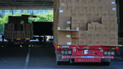 Workers transfer goods from a truck at the Xiaomi logistic center, Beijing, May 29, 2026.