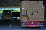 Workers transfer goods from a truck at the Xiaomi logistic center, Beijing, May 29, 2026.