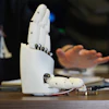 Massachusetts Institute of Technology mechanical engineering graduate student Dian Li demonstrates how an ultrasound wristband can help a robotic hand mimic full hand motions in Cambridge, Mass, on Tuesday, April 14, 2026.