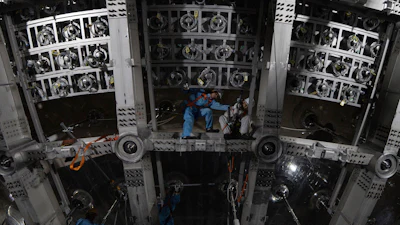Workers labor on the underside of the cosmic detector housed underground at the Jiangmen Underground Neutrino Observatory in Kaiping in southern China's Guangdong province, Oct. 11, 2024.
