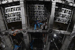 Workers labor on the underside of the cosmic detector housed underground at the Jiangmen Underground Neutrino Observatory in Kaiping in southern China's Guangdong province, Oct. 11, 2024.