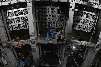 Workers labor on the underside of the cosmic detector housed underground at the Jiangmen Underground Neutrino Observatory in Kaiping in southern China's Guangdong province, Oct. 11, 2024.