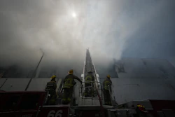 Firefighters fight a warehouse fire in the Boyle Heights neighborhood of Los Angeles, Sunday, June 21, 2026.