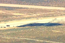 This image taken from video provided by KABC shows law enforcement responding to the scene of an aircraft crash, Monday, June 15, 2026, near Edwards Air Force Base, Calif.