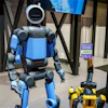 Boston Dynamics received a $25 million award to fund projects tied to manufacturing, workforce training and operations for the company’s Atlas (left), Spot (lower right) and Stretch platforms.