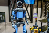 Boston Dynamics received a $25 million award to fund projects tied to manufacturing, workforce training and operations for the company’s Atlas (left), Spot (lower right) and Stretch platforms.