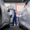 Khatawut Junsongsaeng, a charging station manager, walks past two Chinese-made electric vehicles at a parking lot in Bangkok, Thailand on June 4, 2026.