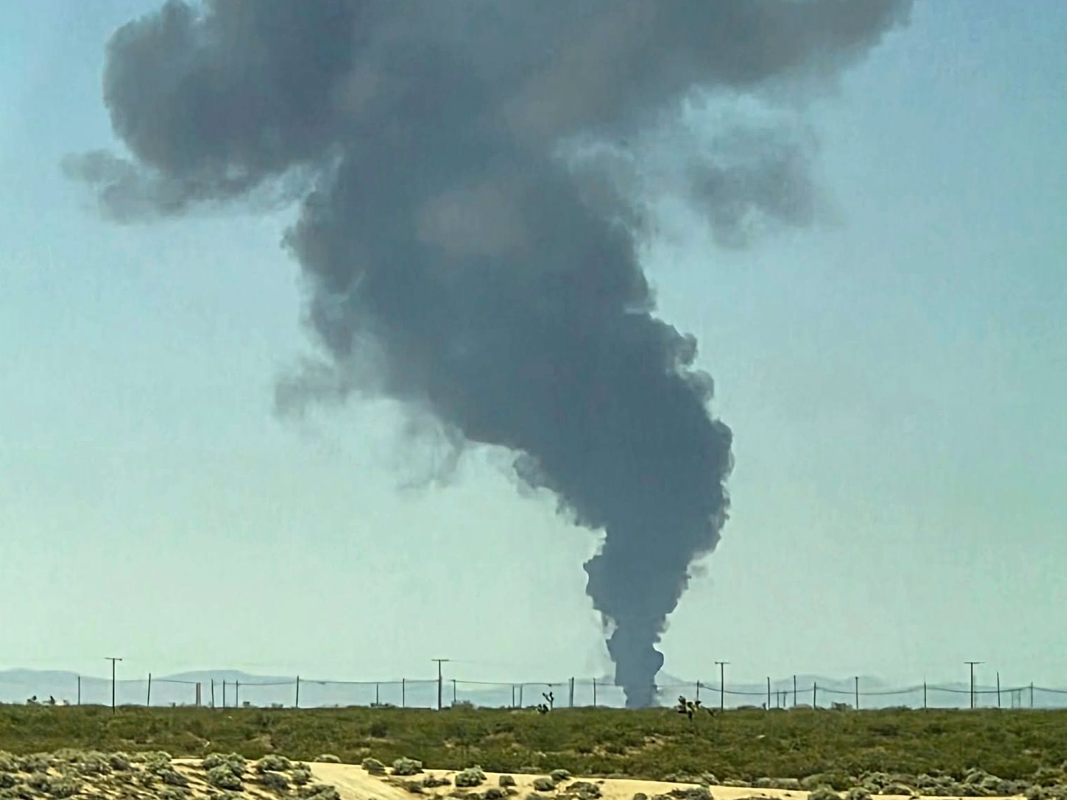 Smoke plumes rise from a B-52 bomber that crashed shortly after takeoff at a U.S. Air Force base in Southern California, Monday, June 15, 2026.
