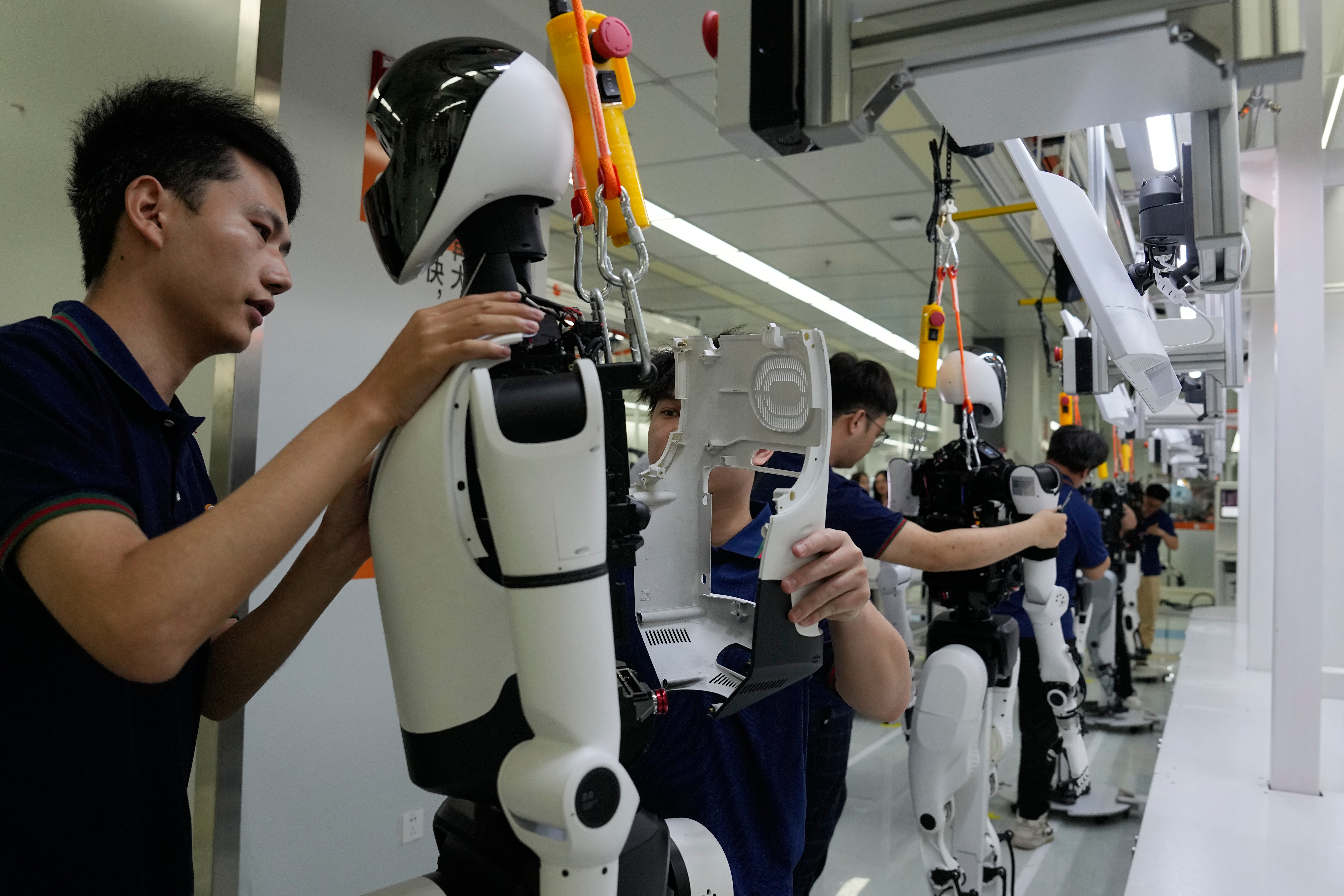 Workers assemble robot at the LY iTech Beijing Super Factory for Embodied Artificial Intelligence during a media tour in the Beijing E-Town on the outskirts of Beijing on May 29, 2026.