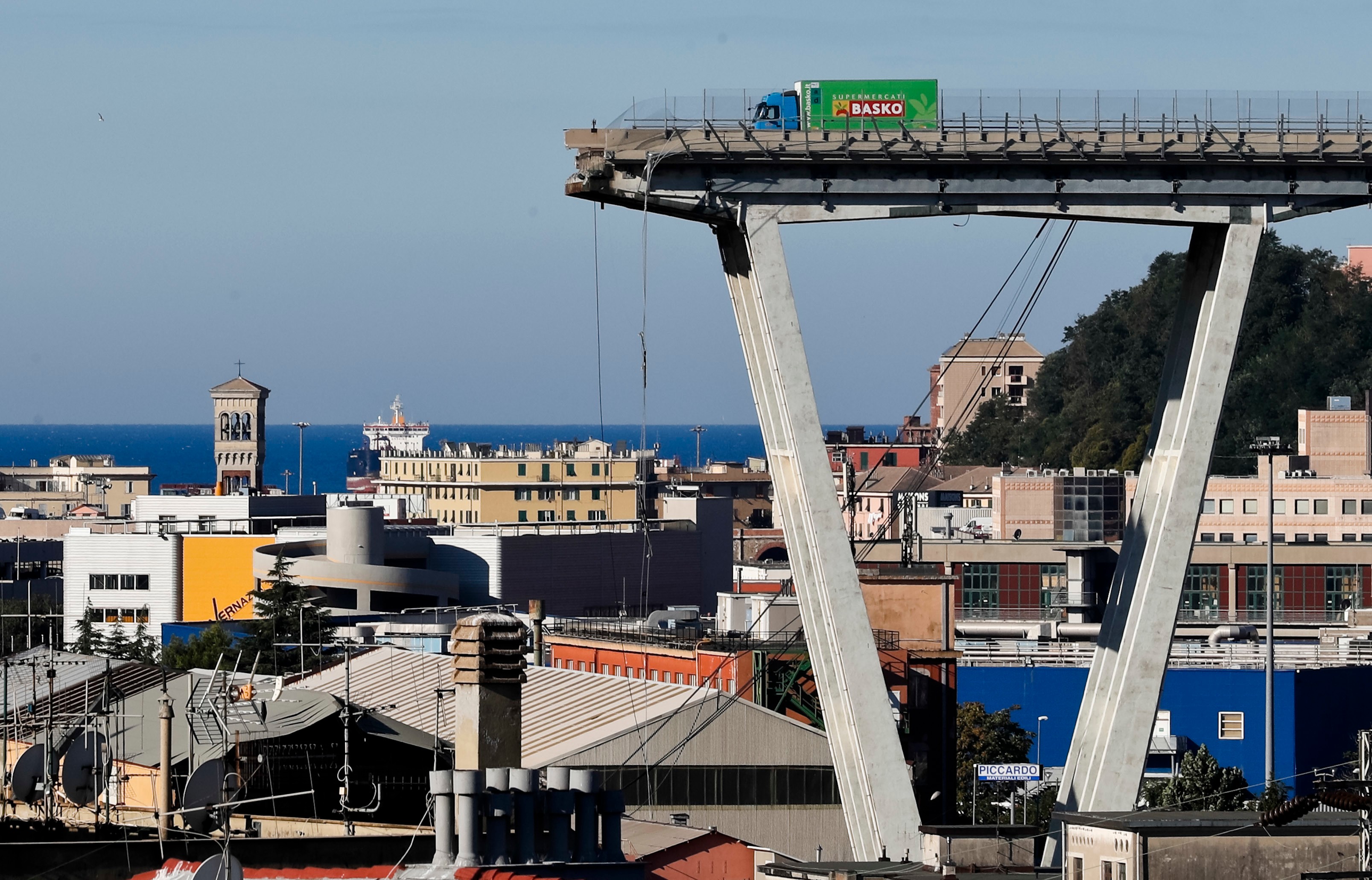 A vehicle sits short of a section of the Morandi highway bridge that collapsed on Aug. 15, 2018, in Genoa, northern Italy.