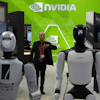 A worker stands near robots at the Nvidia booth during the China International Supply Chain Expo in Beijing on June 22, 2026.