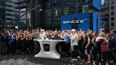 SpaceX employees celebrate during a closing bell ceremony for the IPO of SpaceX at the Nasdaq MarketSite in New York, Friday, June 12, 2026, in New York.