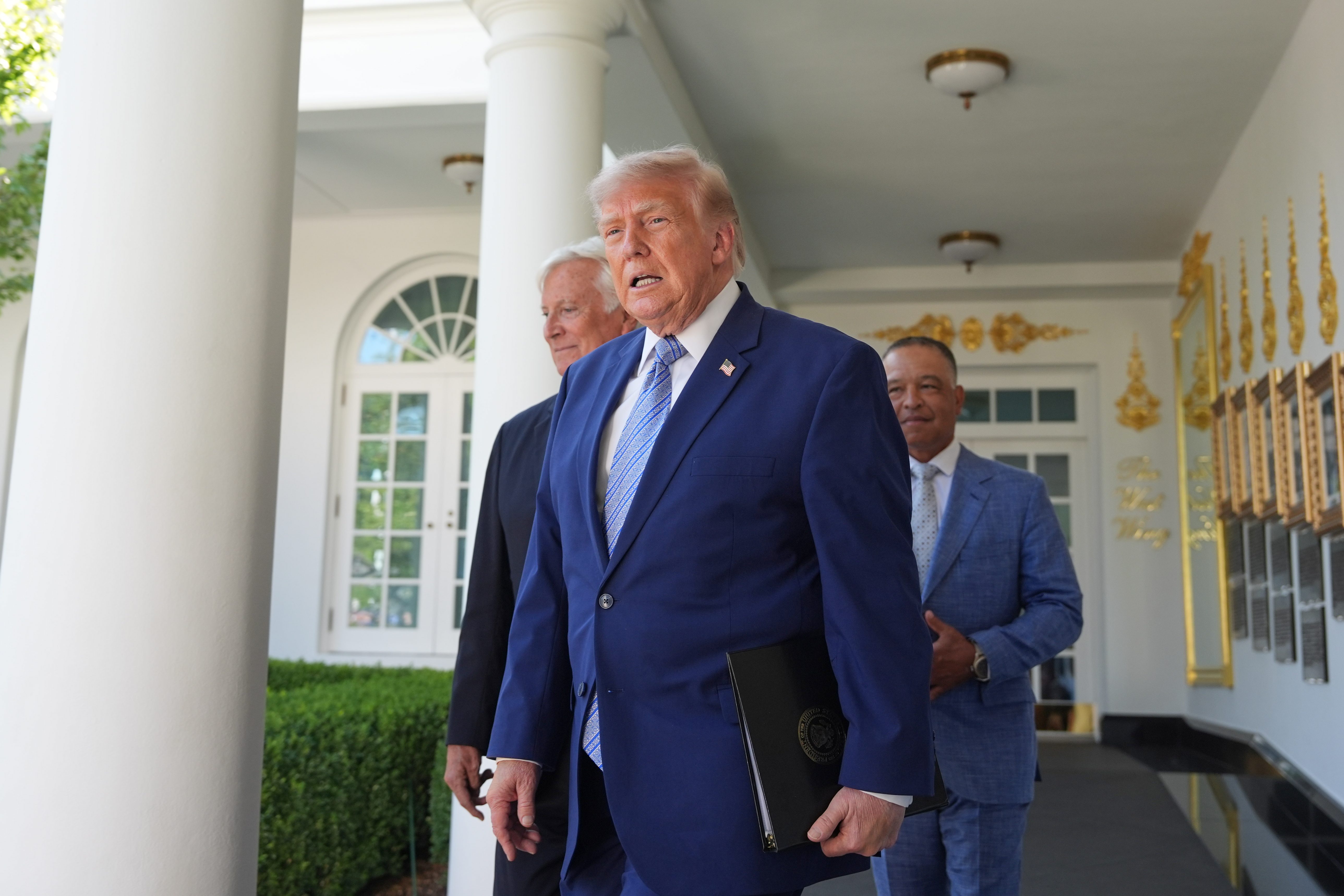 President Donald Trump arrives with Los Angeles Dodgers manager Dave Roberts and owner Mark Walter for an event to honor the 2025 World Series champions Los Angeles Dodgers in the Rose Garden of the White House, Thursday, July 23, 2026, in Washington.