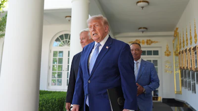 President Donald Trump arrives with Los Angeles Dodgers manager Dave Roberts and owner Mark Walter for an event to honor the 2025 World Series champions Los Angeles Dodgers in the Rose Garden of the White House, Thursday, July 23, 2026, in Washington.