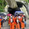 Members of the rescue team carry oxygen cylinders outside the entrance to an under-construction tunnel at a hydropower project in Samardung village, about 40 kilometers (25 miles) from Gangtok, India, Tuesday, July 21, 2026.