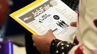 A job seeker waits to talk to a recruiter at a job fair in Sunrise, Fla., Aug. 28, 2025.
