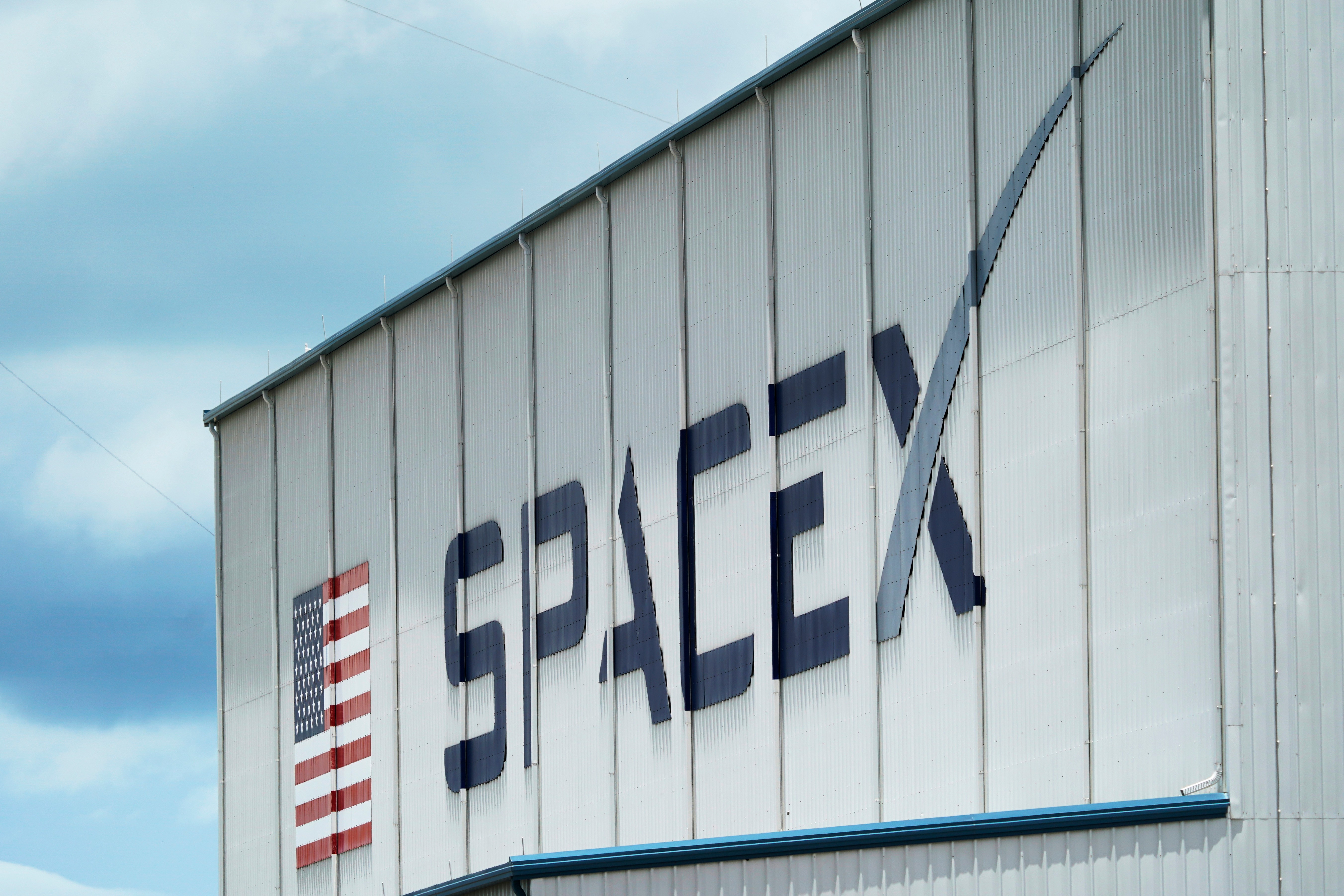 The SpaceX logo is displayed on a building, May 26, 2020, at the Kennedy Space Center in Cape Canaveral, Fla.