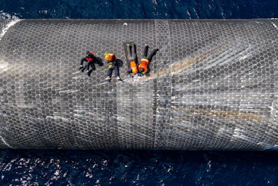 This image provided by SpaceX on Aug. 27, 2026, shows engineers inspecting Starship off the coast of Christmas Island in the Indian Ocean, following its launch on a test flight back in July.