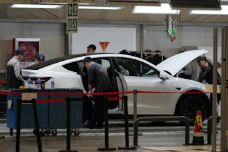People work on the Tesla Model Y production line at the Tesla Gigafactory assembly plant during a media organized tour, in Shanghai, China, Tuesday, April 14, 2026.