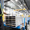 Workers prepare extruded aluminum product for packaging at Magna Aluminum Profile's fully electric powered extrusion facility in Salaberry-de-Valleyfield, Quebec, Canada, on Sept. 3, 2025.