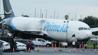 Workers inspect an Amazon cargo plane that overshot a runway four days ago at Miami International Airport, Thursday, Sept. 10, 2026, in Miami.
