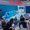 People visit the booth for Chinese AI-computing chip start up Dongfang Suanxin during the World AI Conference in Shanghai, July 17, 2026.