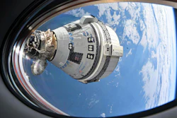 Boeing Starliner spacecraft docked to International Space Station above Earth with blue sky and clouds visible