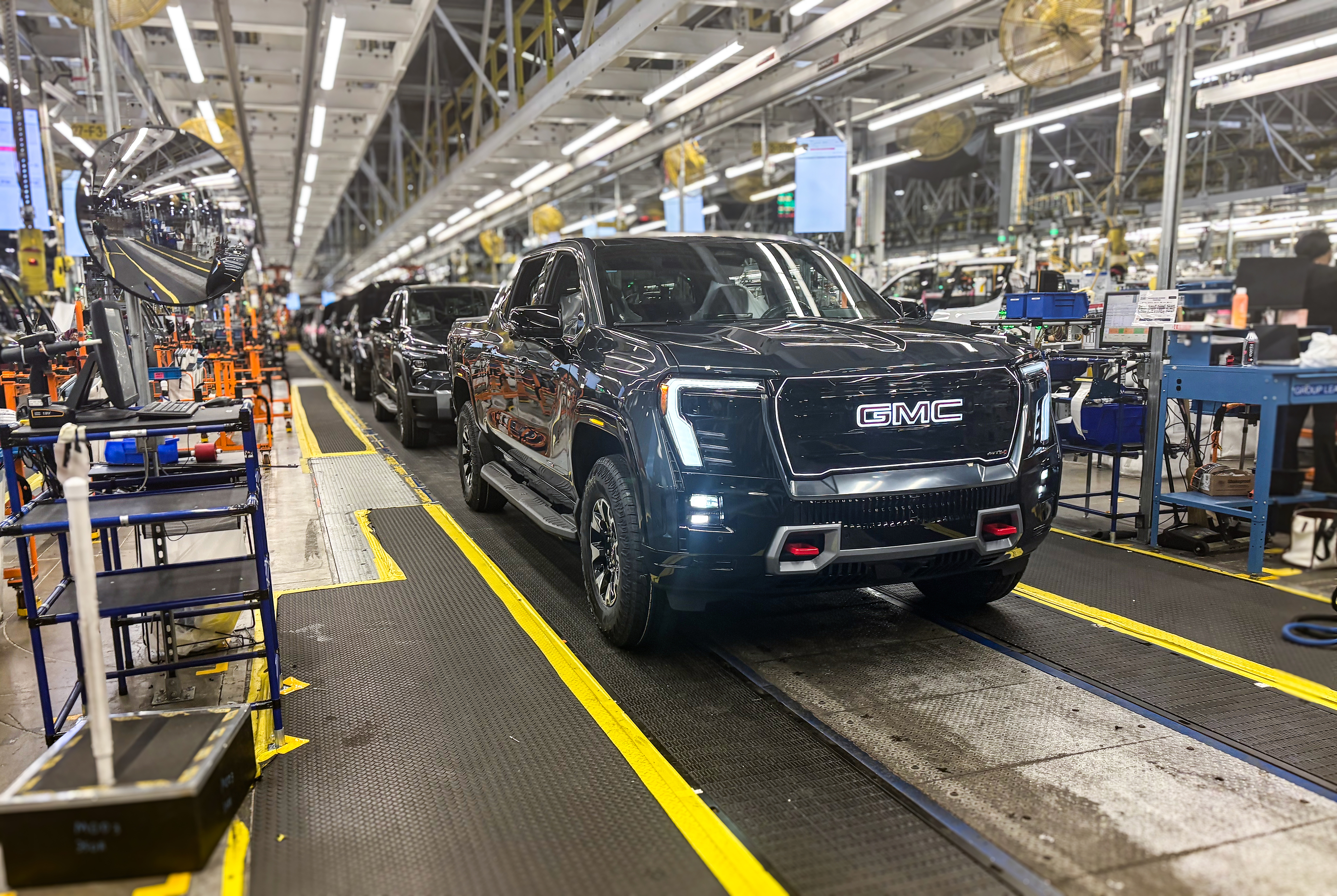 A GMC Sierra EV with battery cells made from recycled materials rolls off the line at GM’s Factory ZERO assembly facility.