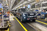 A GMC Sierra EV with battery cells made from recycled materials rolls off the line at GM’s Factory ZERO assembly facility.