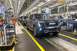 A GMC Sierra EV with battery cells made from recycled materials rolls off the line at GM’s Factory ZERO assembly facility.