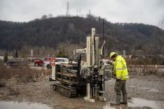 A technician pulls soil samples.