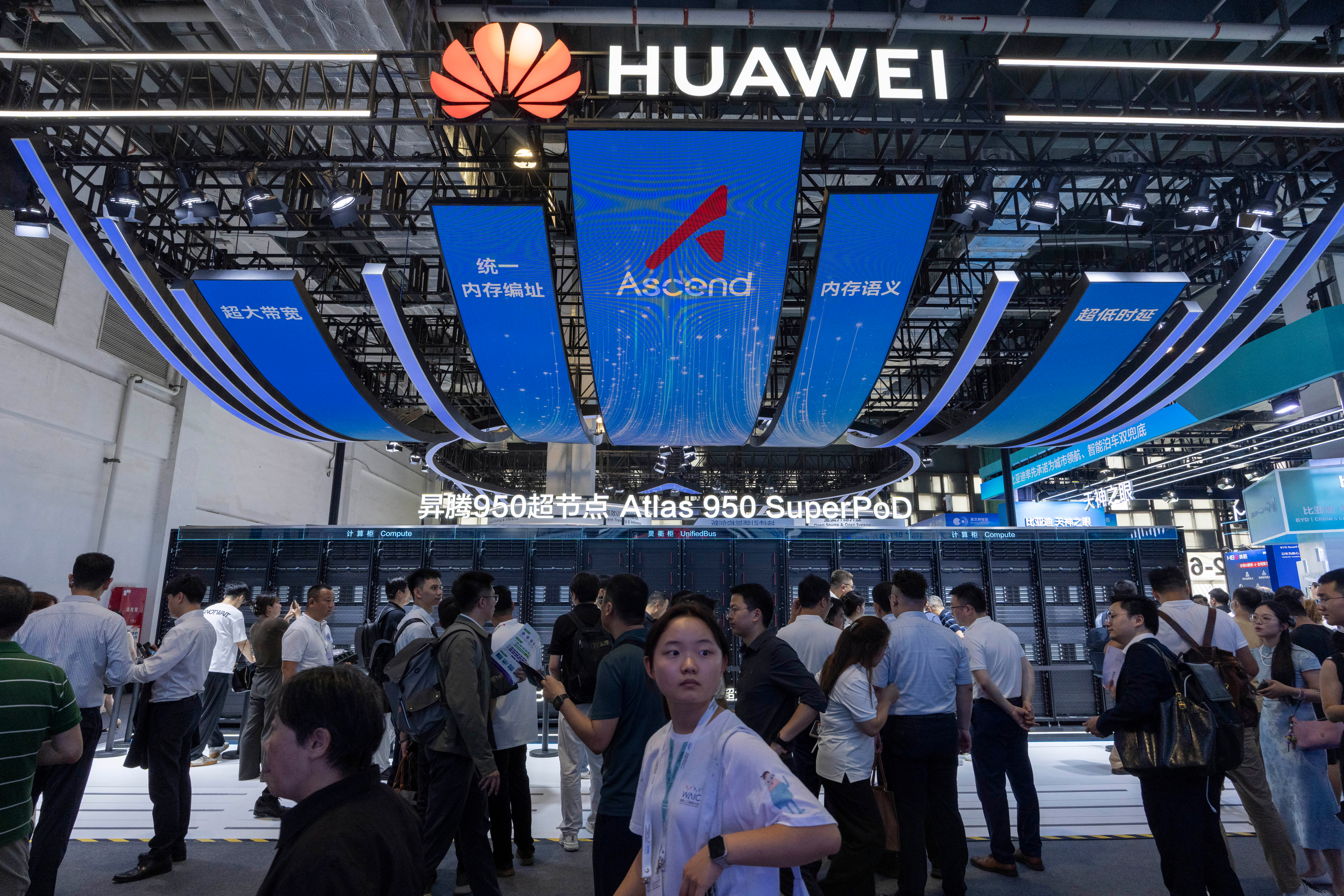Visitors past by the Huawei booth display of the Atlas 950 SuperPoD during the World AI Conference in Shanghai, China on Friday, July 17, 2026.